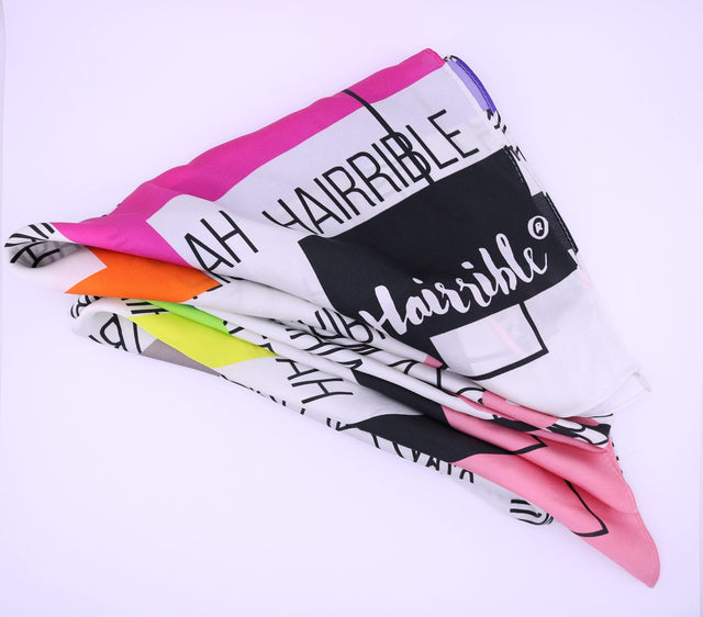 Neon Repeat (Hairrible®) silk scarf folded in neat triangle